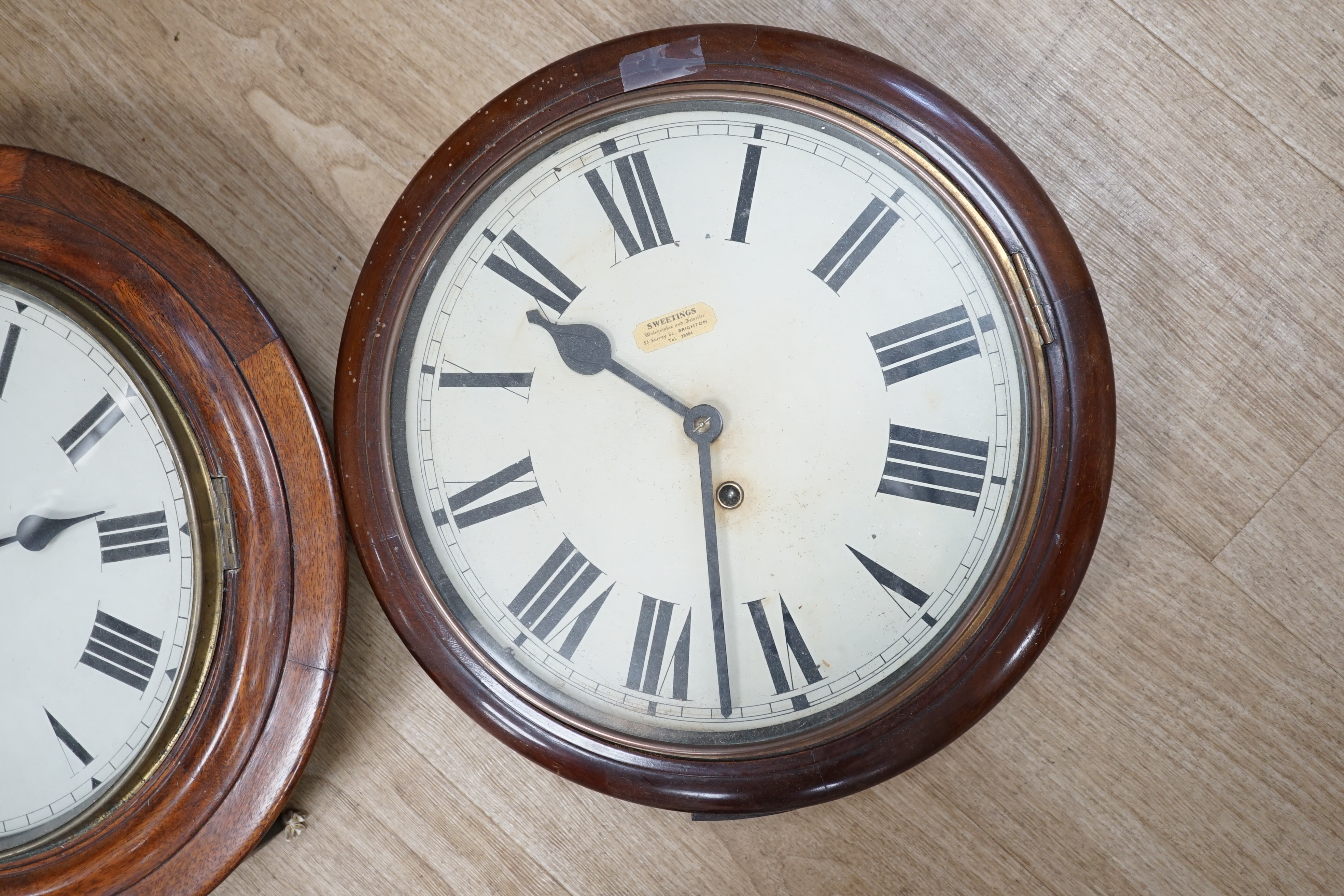 Two early 20th century circular mahogany dial clocks, largest diameter 43cm